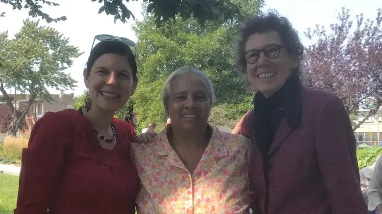 Three women smiling together in the garden: the Rev. Celeste Groff, Ms. Erma Purnell and Ms. Joan Gerig